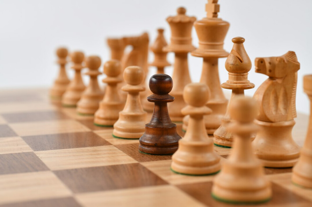 Close-up of chess pieces on a wooden board, strategic game